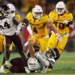 Running back Cam Skattebo #4 of the Arizona State Sun Devils slips through a tackle by defensive lineman Kedrick Bingley-Jones #22 of the Mississippi State Bulldogs during the first half at Mountain America Stadium on Sept. 7, 2024 in Tempe. Chris Coduto/Getty Images